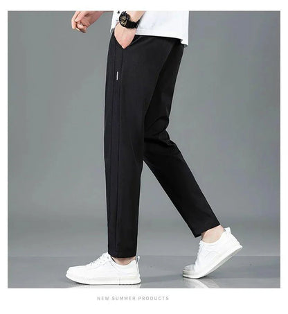 Mandotos Ice Silk men's summer pants in black and gray with straight leg fit, breathable elastic fabric, suitable for casual or outdoor wear.