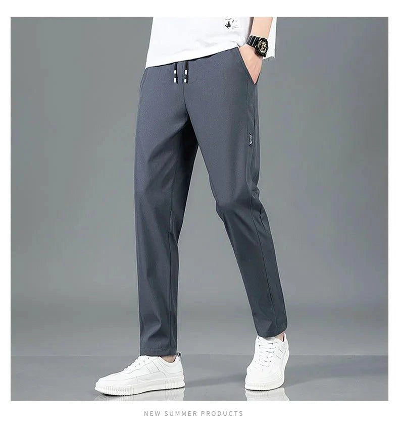 Mandotos Ice Silk men's summer casual pants in black and gray, breathable, elastic, straight-leg sweatpants for outdoor or business wear.