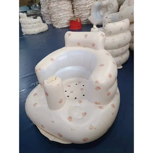 Inflatable baby chair by MANDOTOS designed for dining and bath use, featuring a soft, colorful seat with safety features.