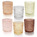Set of 12 multicolor glass tealight holders by MANDOTOS INTERNATIONAL, ideal for special occasions and decorative lighting.