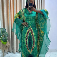 African Dashiki Ankara maxi dress for women by MANDOTOS INTERNATIONAL, featuring vibrant traditional African fabric and long flowing style.