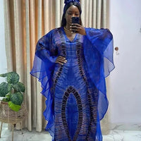 African Dashiki Ankara maxi dress for women by MANDOTOS INTERNATIONAL, featuring vibrant traditional floral patterns and flowing long style.