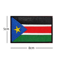 Embroidery patches featuring African flags and badges of Morocco, Nigeria, Gabon, Libya, and Namibia by MANDOTOS INTERNATIONAL.