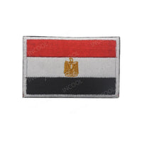 Embroidery patches featuring African flags and badges from Morocco, Nigeria, Gabon, Libya, and Namibia by MANDOTOS INTERNATIONAL.