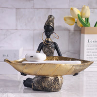 African girl holding a plate sculpture by MANDOTOS INTERNATIONAL, vintage decorative storage ornament for home or office decor.