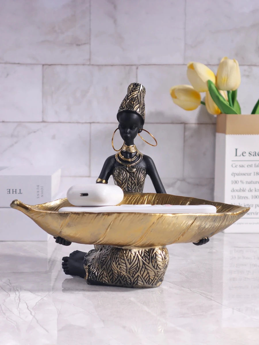 African girl holding a plate sculpture by MANDOTOS INTERNATIONAL, vintage decorative storage ornament for home or office decor.