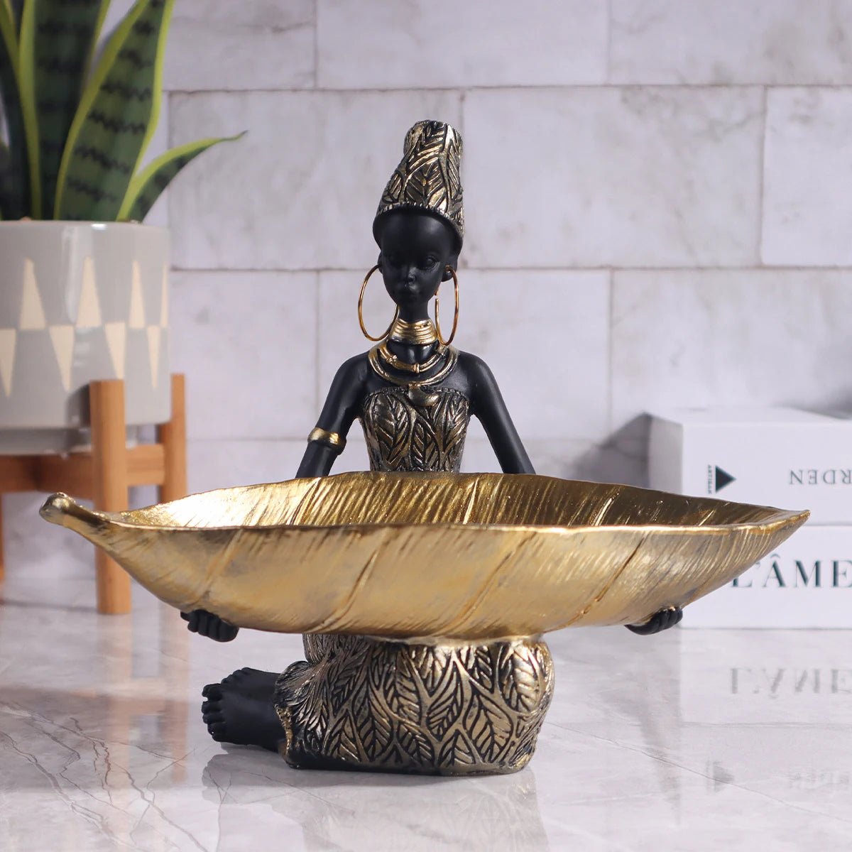 African girl holding a plate sculpture by MANDOTOS INTERNATIONAL, vintage decorative storage ornament for home and office decor.