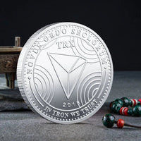 Mandotos International physical metal crypto currency coin collection featuring Bitcoin, Ethereum, Dogecoin, Litecoin, and more in a plastic case.