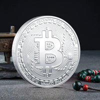 Mandotos International collection of physical metal crypto coins including Bitcoin, Ethereum, Dogecoin, and more in a plastic case.