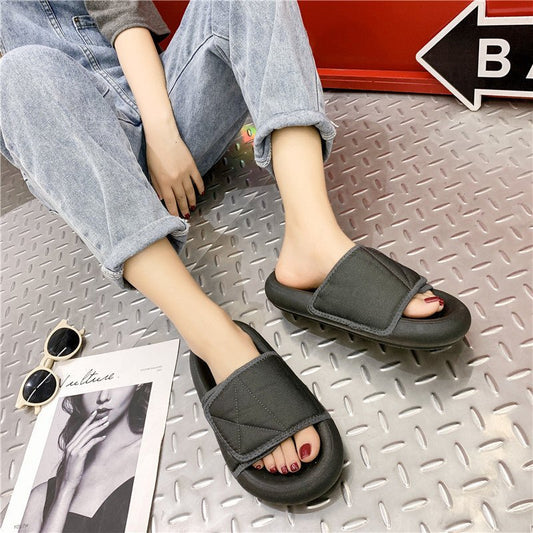 Chic grey beach sandals with comfortable sole by MANDOTOS INTERNATIONAL, featuring open-toe design and slip-on style.
