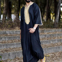 Elegant men's black linen robe by Mandotos International, showing the soft fabric and relaxed fit on a hanger.