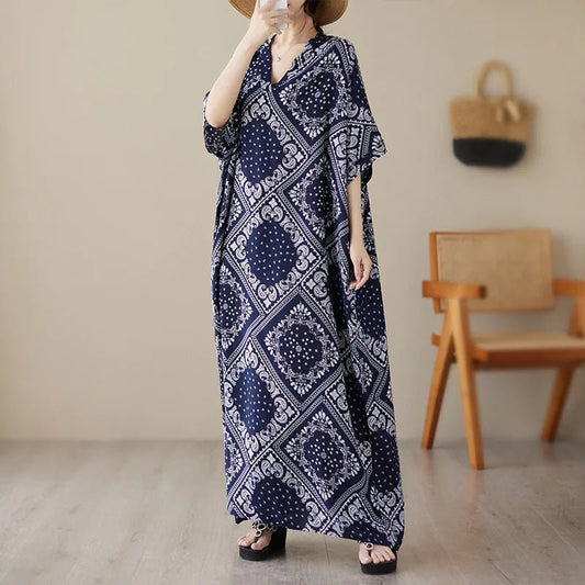 Ethnic Bohemian beach dress for women, casual and fashionable, featuring vibrant patterns and flowing fabric by MANDOTOS INTERNATIONAL.