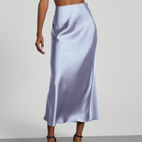European American style satin midi skirt by MANDOTOS INTERNATIONAL, featuring smooth fabric and a stylish midi length.