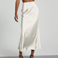 European American style satin midi skirt by MANDOTOS INTERNATIONAL, shown in a sleek, elegant design, in stock for wholesale purchase.