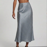 European American style satin midi skirt from MANDOTOS INTERNATIONAL, showcasing smooth fabric and elegant design.