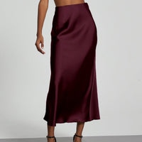 European American style satin midi skirt by MANDOTOS INTERNATIONAL, featuring smooth fabric and a classic midi length.