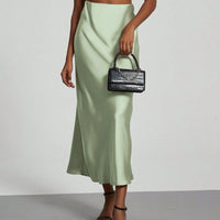 European American style satin midi skirt by MANDOTOS INTERNATIONAL, featuring a smooth, shiny fabric and elegant midi length.