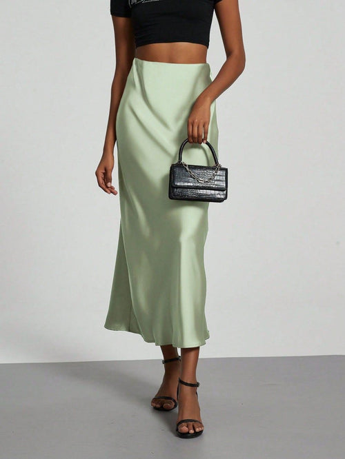 European American style satin midi skirt by MANDOTOS INTERNATIONAL, featuring a smooth, shiny fabric and elegant midi length.