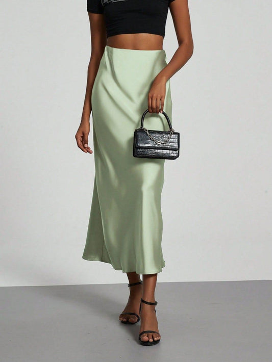 European American style satin midi skirt by MANDOTOS INTERNATIONAL, featuring a smooth, shiny fabric and elegant midi length.