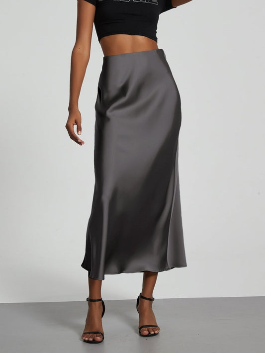 European American style satin midi skirt by MANDOTOS INTERNATIONAL, showcasing a sleek, elegant design in a natural pose.