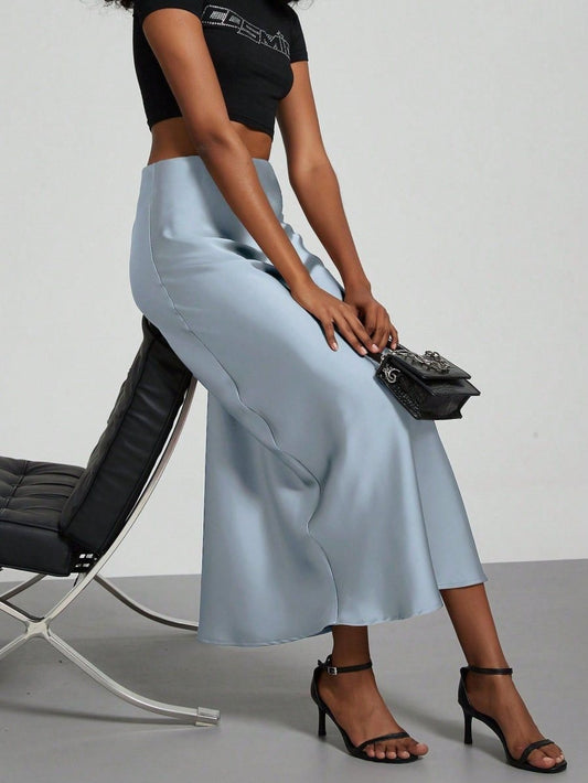 European American style satin midi skirt by MANDOTOS INTERNATIONAL, showcasing a sleek, elegant design with a smooth satin finish.