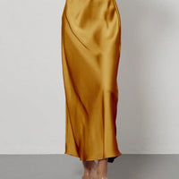 European American style satin midi skirt by MANDOTOS INTERNATIONAL, shown in a stylish, flowing design with a smooth satin finish.