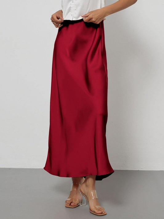 European American style satin midi skirt by MANDOTOS INTERNATIONAL, shown in a stylish, flowing design on a model.