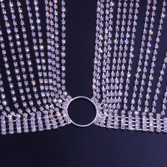 Geometric bikini chest chain by MANDOTOS INTERNATIONAL with crystal and rhinestone accents, draped over a model's torso.