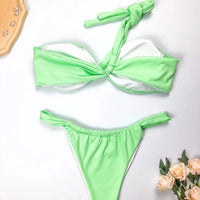 Eco-friendly women's one-shoulder bikini set by MANDOTOS INTERNATIONAL, featuring a sexy split design in recycled fabric.
