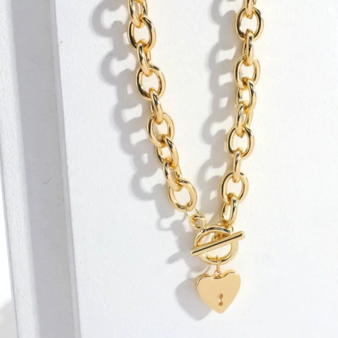 Silver Heart Key Toggle Necklace by MANDOTOS INTERNATIONAL featuring a delicate heart-shaped key pendant on a chain.