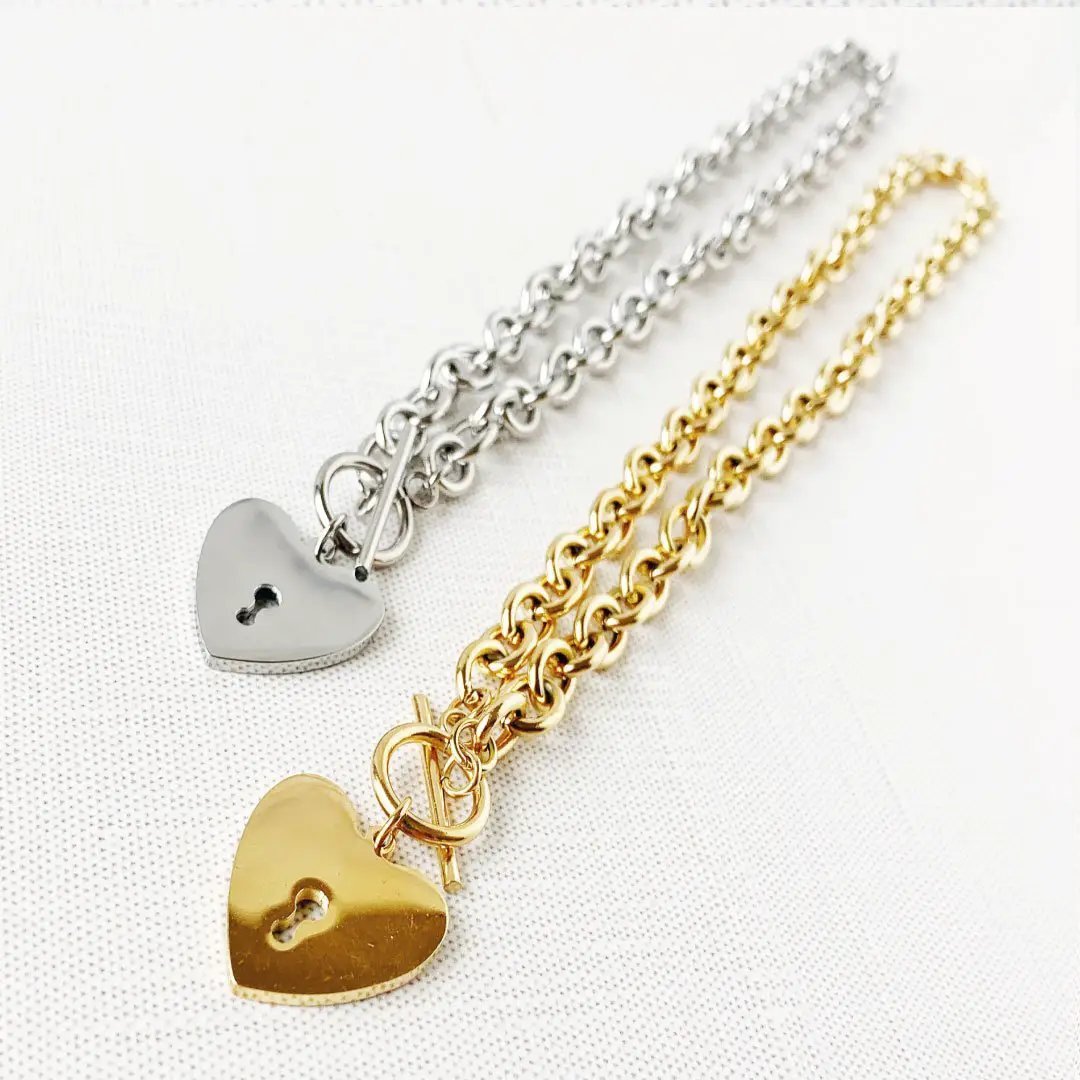 Mandotos International heart-shaped key toggle necklace featuring a delicate chain and charm for elegant jewelry style.