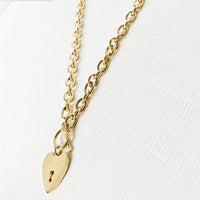 Heart-shaped key toggle necklace by MANDOTOS INTERNATIONAL featuring a delicate chain and a detailed heart key pendant.