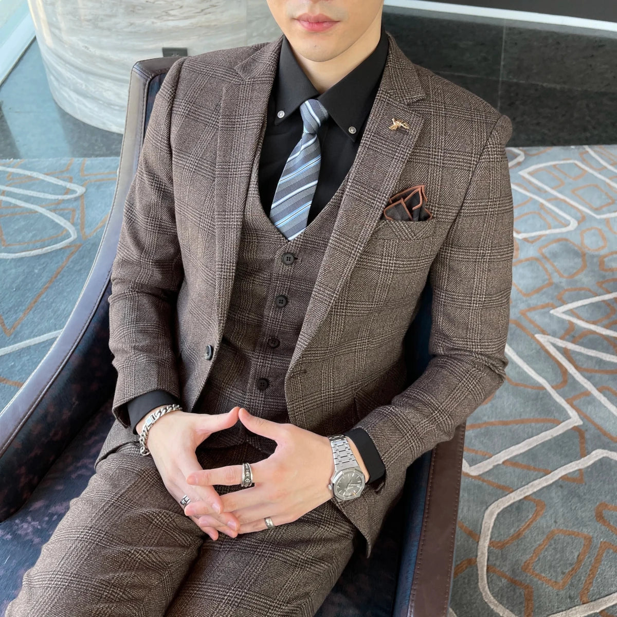 British Korean style plaid men's 3-piece business casual suit set by MANDOTOS INTERNATIONAL, featuring a tailored jacket, vest, and trousers.