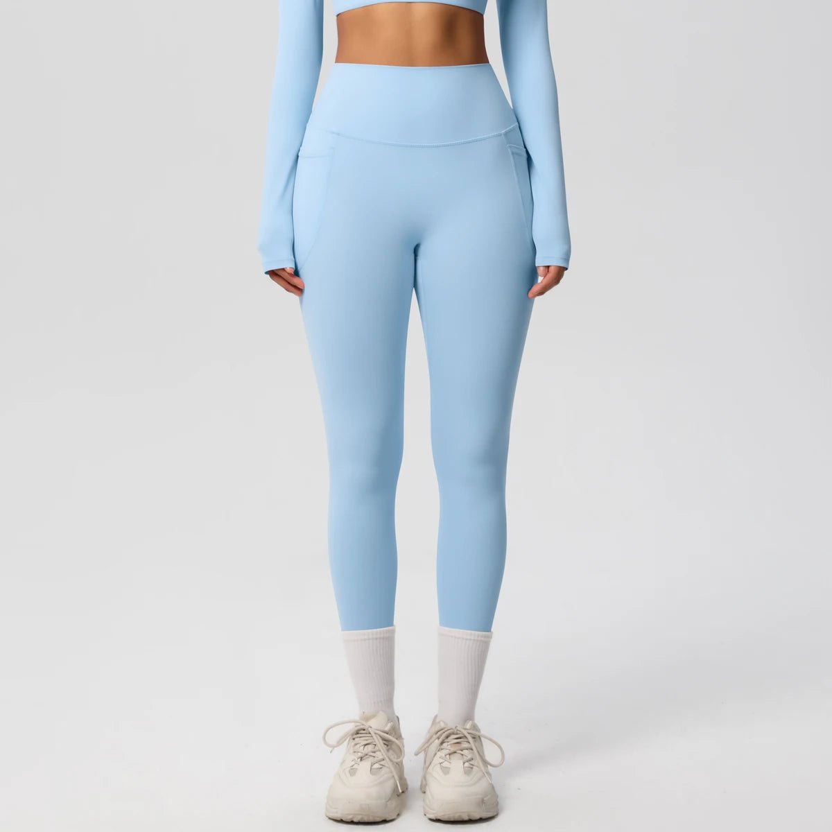 High waist women's Mandotos International yoga leggings with pockets, stretchy fabric, push-up fit, ideal for running and fitness.