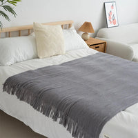 Knitted wool throw with tassels from MANDOTOS INTERNATIONAL, cozy home decor and travel blanket in soft, warm fabric.