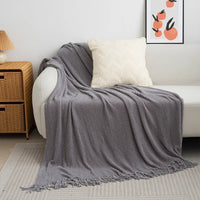 Knitted wool throw blanket with tassels by MANDOTOS INTERNATIONAL, cozy home decor and travel blanket in soft, warm wool.