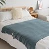 Knitted wool throw blanket with tassels by MANDOTOS INTERNATIONAL, cozy home decor and travel blanket in soft, warm fabric.