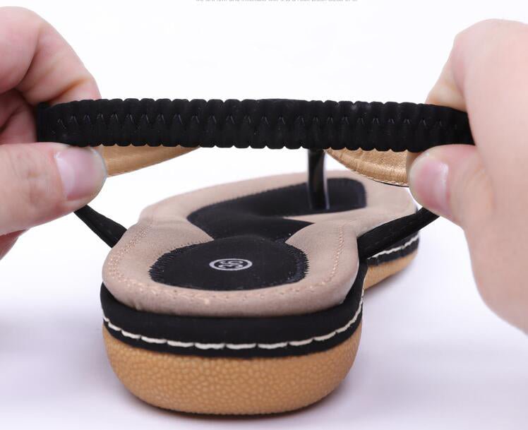 Ladies' chic beach flip flops by MANDOTOS INTERNATIONAL featuring stylish straps and comfortable sole for summer wear.