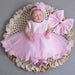 Little Princess gown by MANDOTOS INTERNATIONAL featuring a pink ruffled dress with satin bow, perfect for young princesses.