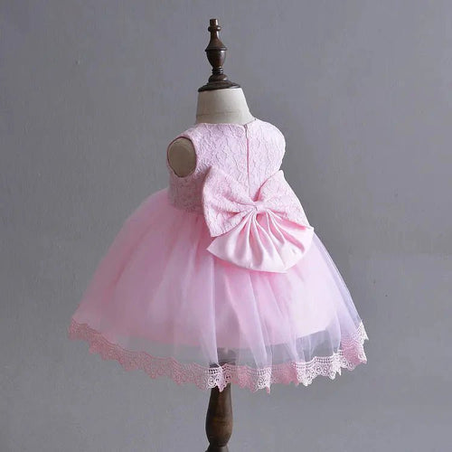 Little Princess gown by MANDOTOS INTERNATIONAL featuring a pink dress with floral details and a tulle skirt.