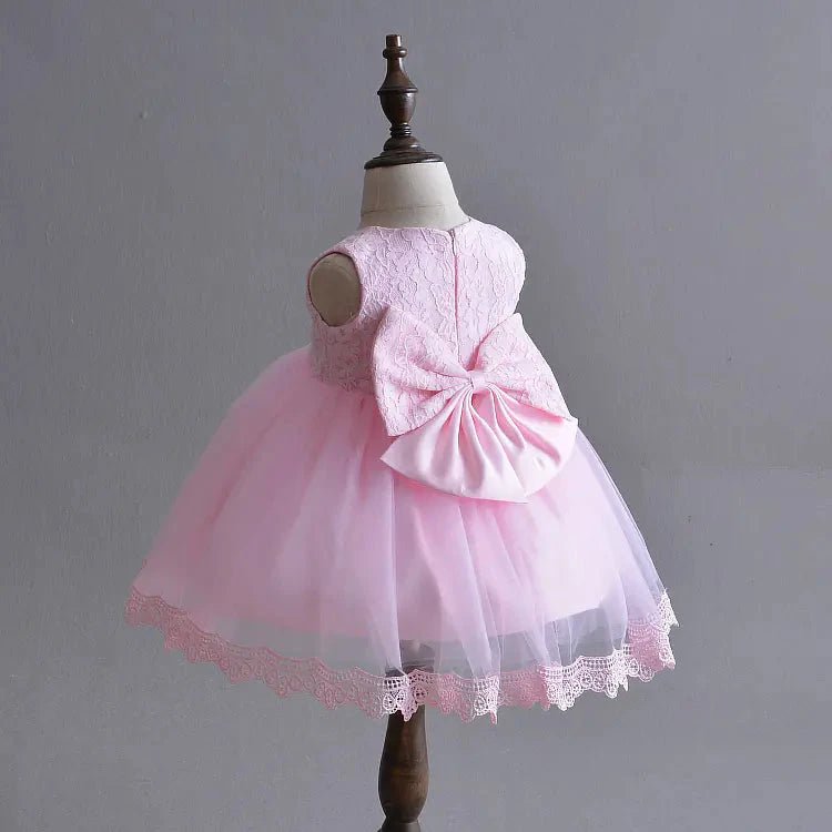 Little Princess gown by MANDOTOS INTERNATIONAL featuring a pink dress with floral details and a tulle skirt.