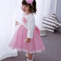 Pink Little Princess gown by MANDOTOS INTERNATIONAL with ruffled sleeves and satin bow, perfect for special occasions.