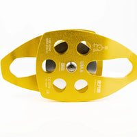 Mandotos International custom single fixed mountaineering pulley for outdoor climbing, shown with climbing ropes in a travel kit setup.