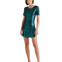 Mandotos International Marcella Sequin Tee Dress shown in a stylish fit with shimmering sequin details on the fabric.