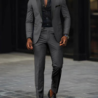 Men's slim-fit business casual suit jacket and trousers by MANDOTOS INTERNATIONAL, shown on a model.