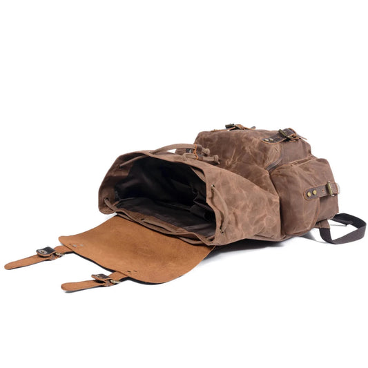 Men's vintage batik canvas and leather backpack by Mandotos International showing sturdy straps and traditional batik pattern.