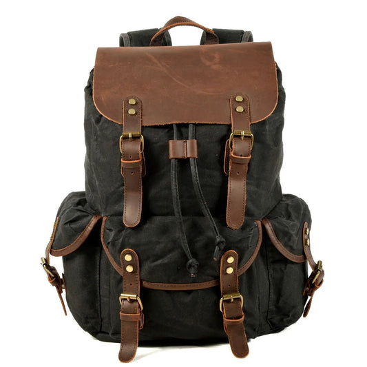 Men's vintage batik canvas leather backpack with adjustable straps, multiple pockets, and classic design from Mandotos International.