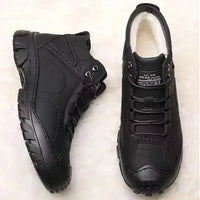 Men's winter ankle boots by MANDOTOS INTERNATIONAL, waterproof and non-slip work shoes, showing sturdy design and rugged soles.