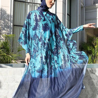 Mandotos International modest coverage Muslim burkini with stylish design, full-body swimwear for middle-aged women, shown on a woman at the beach.