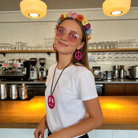Pesenar 60s hippie costume accessory set includes flower headband, pink sunglasses, and peace sign jewelry for retro style.